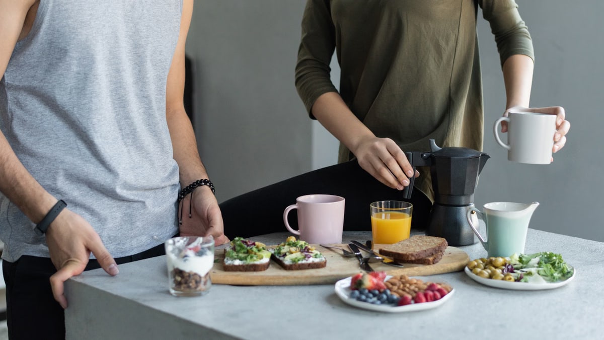 Cozy morning breakfast with avocado toast, coffee, and fresh juice.